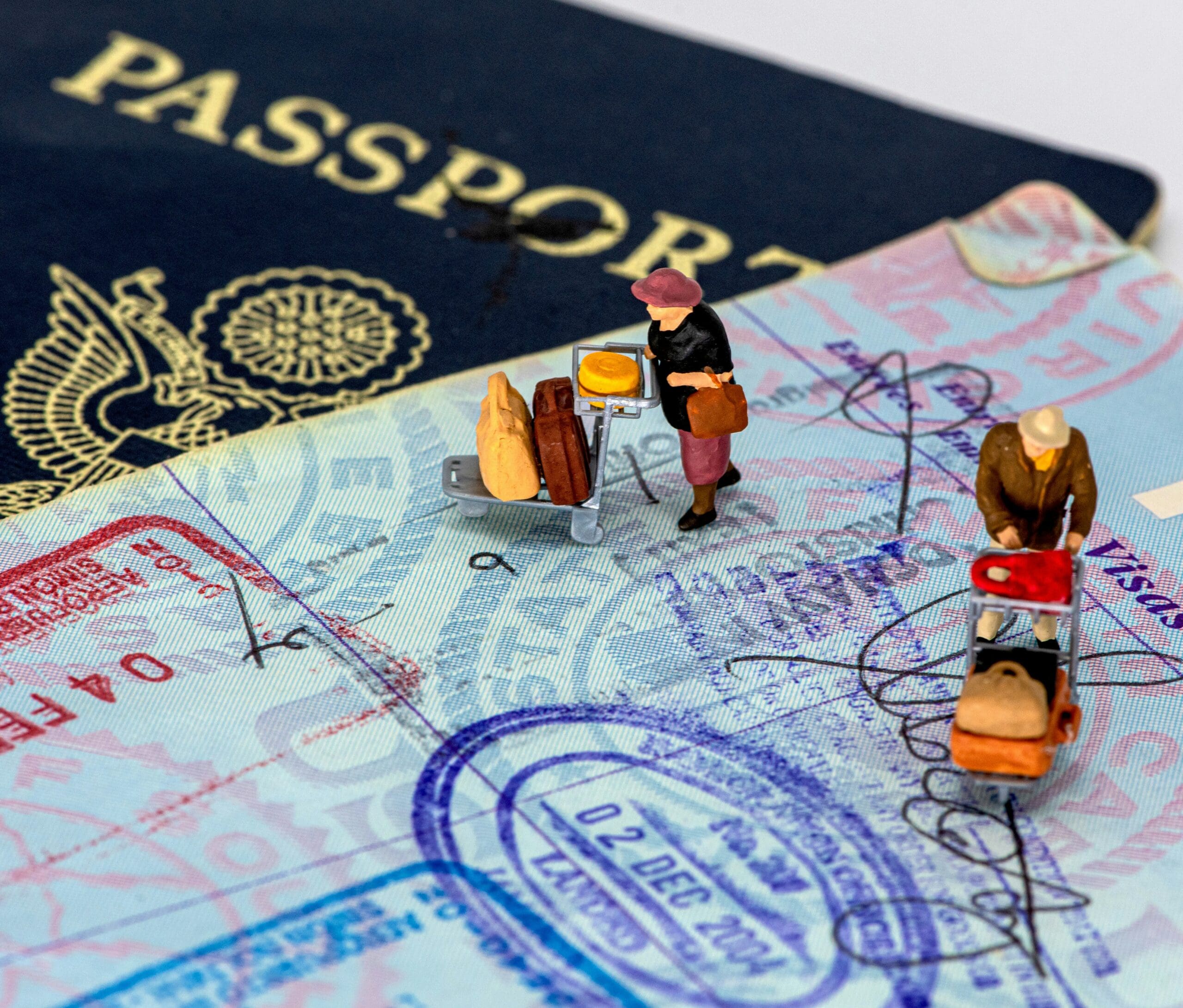 Traveler checking a printed travel itinerary at an airport while holding passport and boarding pass.